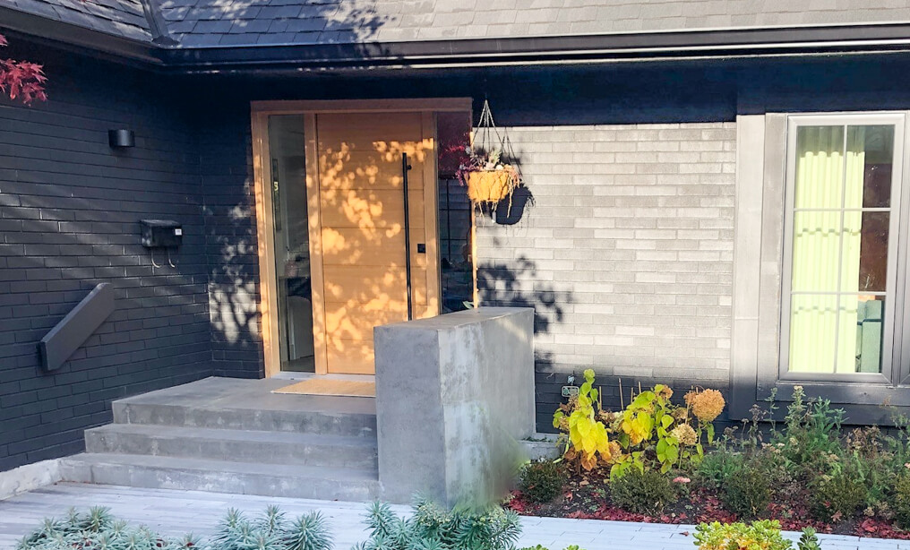 modern wood front entry door with long bar handle